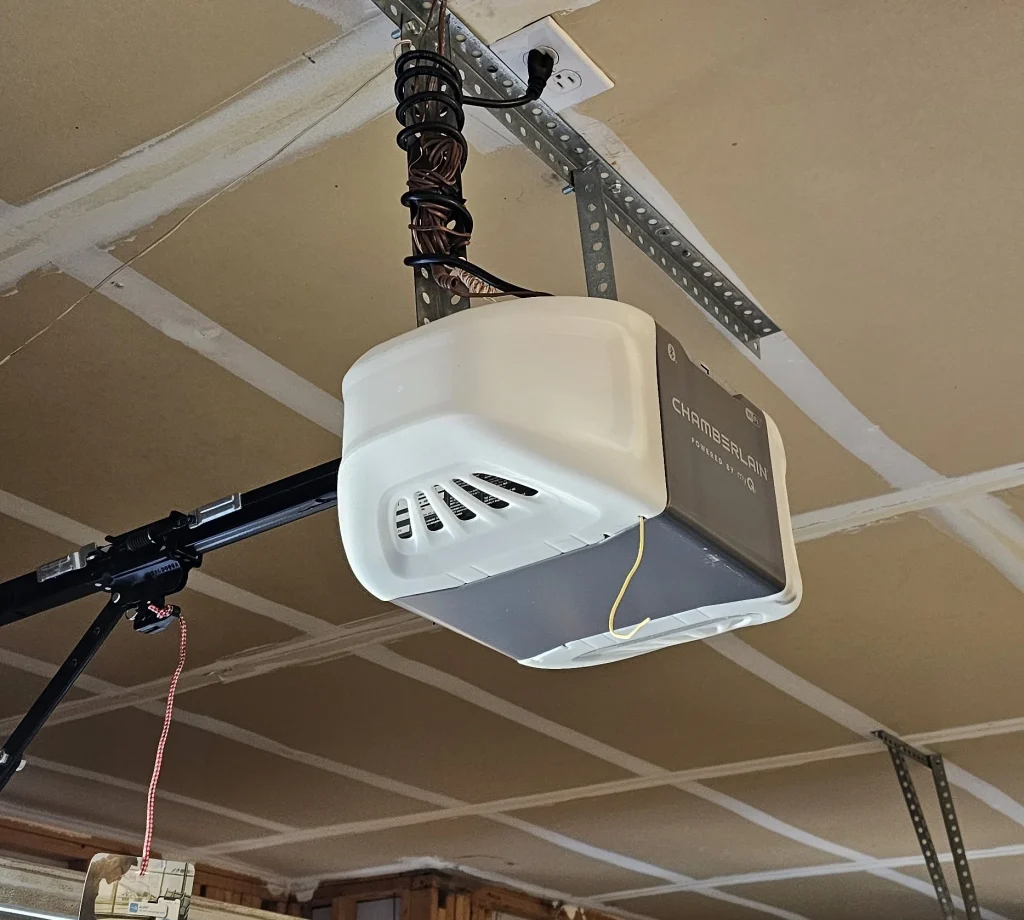 Chamberlain automatic motor head unit securely bolted into a garage ceiling highlights the exact system that benefits from a proactive upkeep schedule, as featured in Benefits of Timely Garage Door Opener Maintenance