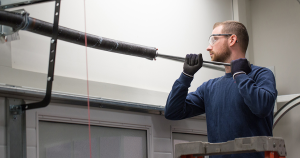 man changing garage door torsion springs