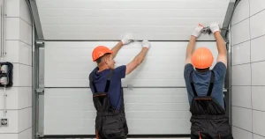 two men working on a garage door