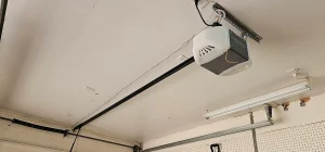 An interior view looking up at a ceiling-mounted Chamberlain automatic opener highlights the primary system components discussed in Clicking Garage Door Opener in Colorado Springs, CO.