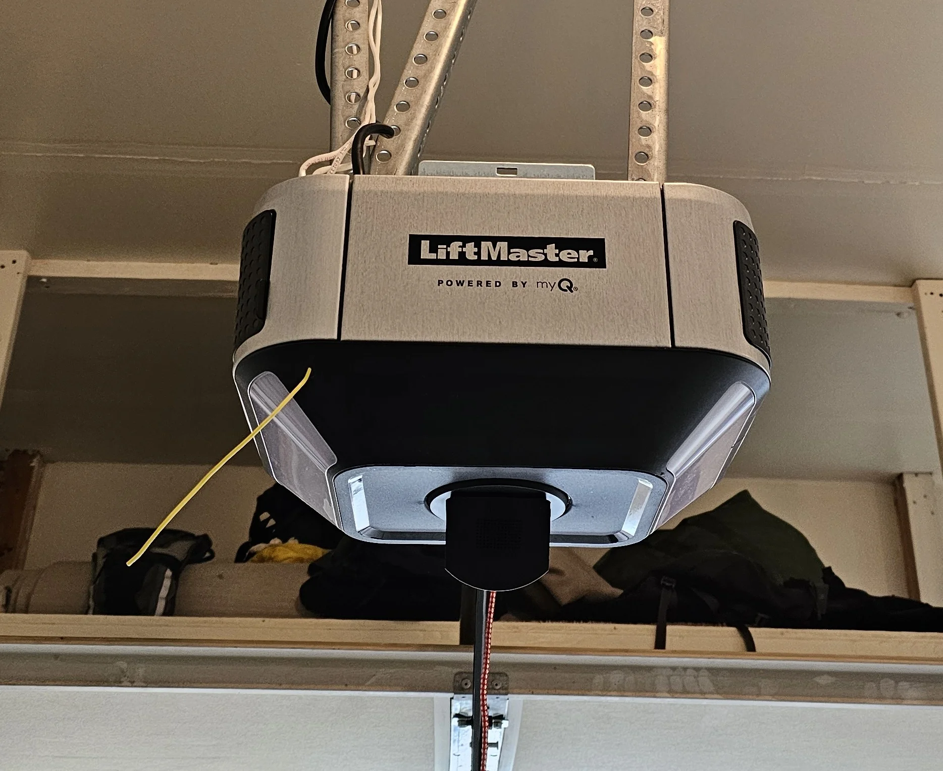 A front-facing view of a ceiling-mounted LiftMaster smart garage door opener frames the motor unit central to Reasons a LiftMaster Garage Door Opener Beeps