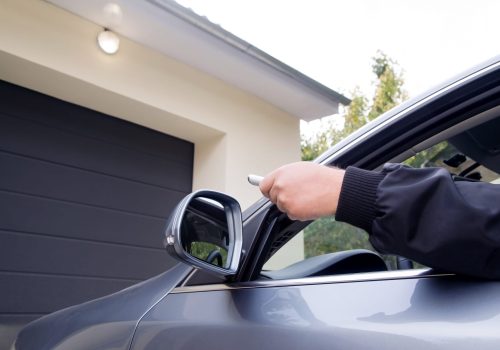 Man by using remote  opens garage